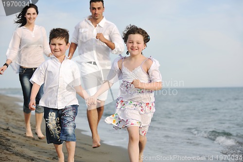 Image of happy young family have fun on beach