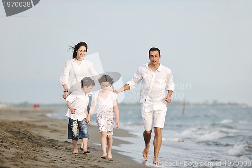 Image of happy young family have fun on beach