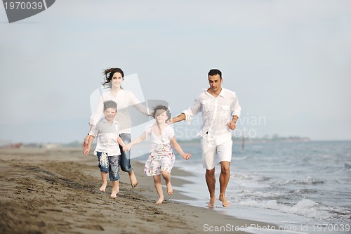 Image of happy young family have fun on beach