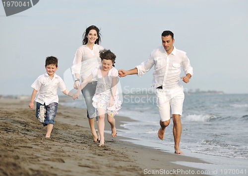 Image of happy young family have fun on beach