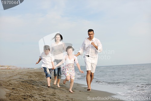Image of happy young family have fun on beach