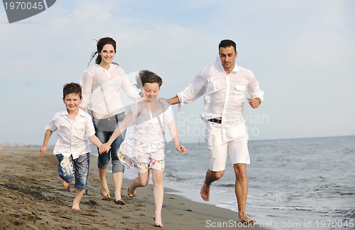 Image of happy young family have fun on beach