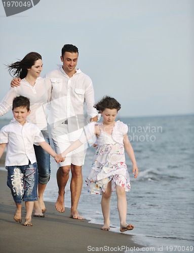 Image of happy young family have fun on beach