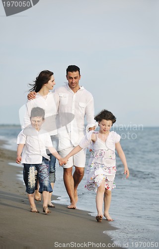 Image of happy young family have fun on beach