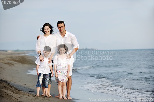 Image of happy young family have fun on beach