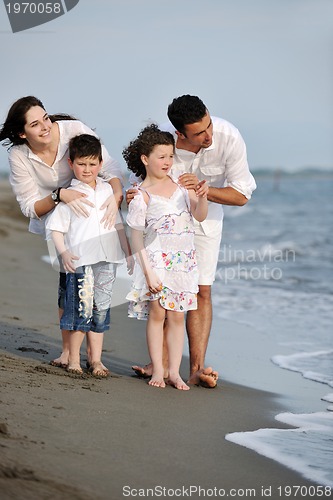 Image of happy young family have fun on beach