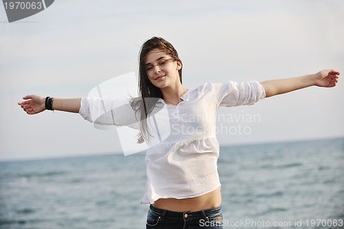 Image of young woman enjoy on beach