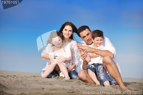 Image of happy young family have fun on beach