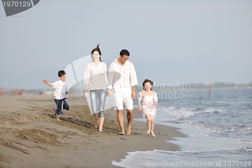Image of happy young family have fun on beach