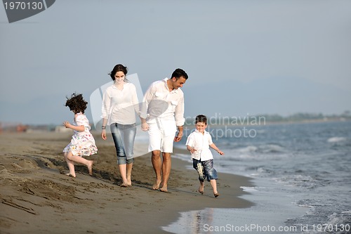 Image of happy young family have fun on beach