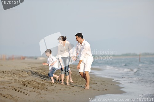 Image of happy young family have fun on beach