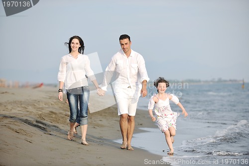 Image of happy young family have fun on beach