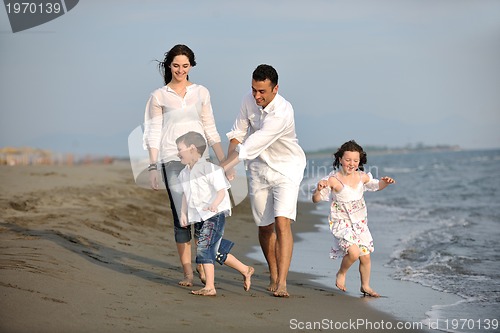 Image of happy young family have fun on beach
