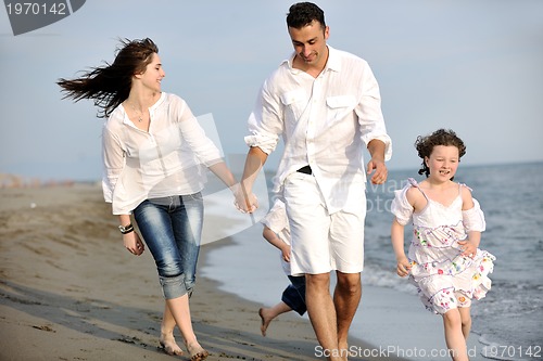 Image of happy young family have fun on beach