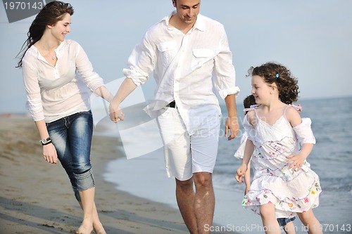 Image of happy young family have fun on beach