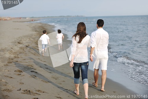 Image of happy young family have fun on beach
