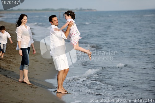 Image of happy young family have fun on beach