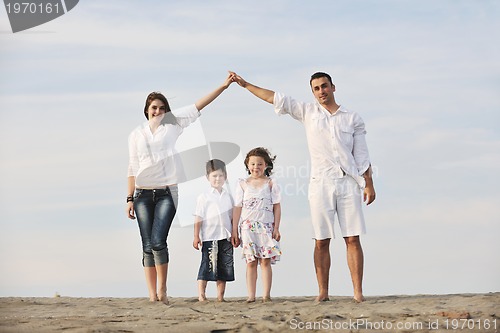 Image of family on beach showing home sign