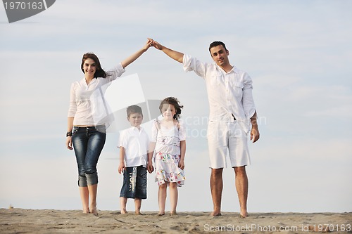 Image of family on beach showing home sign