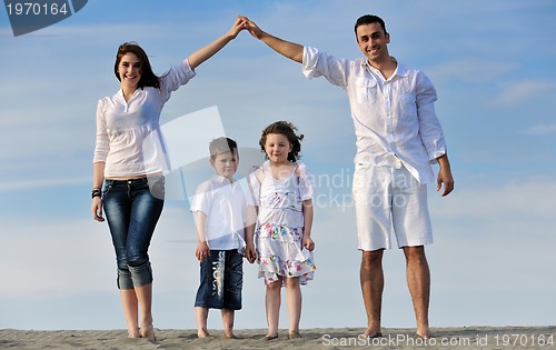 Image of family on beach showing home sign