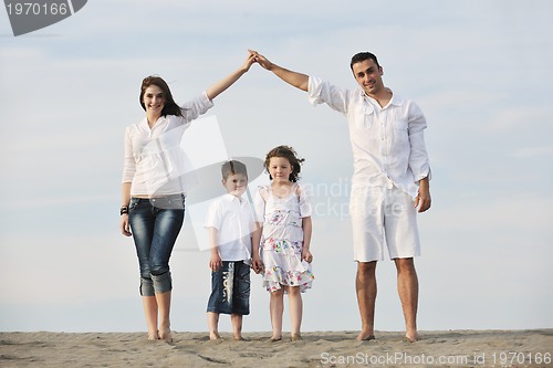 Image of family on beach showing home sign
