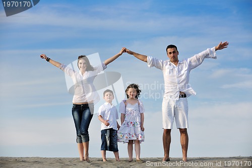 Image of family on beach showing home sign