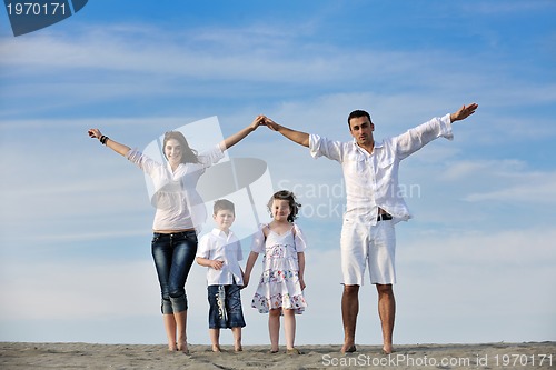 Image of family on beach showing home sign