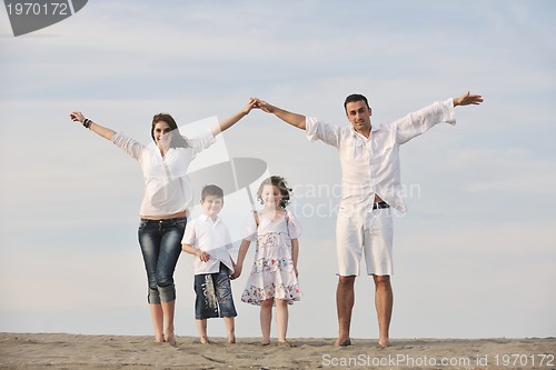 Image of family on beach showing home sign