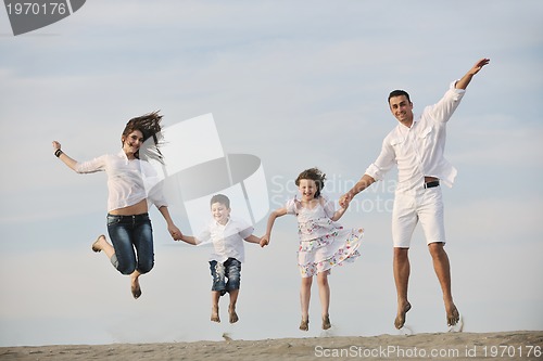 Image of family on beach showing home sign