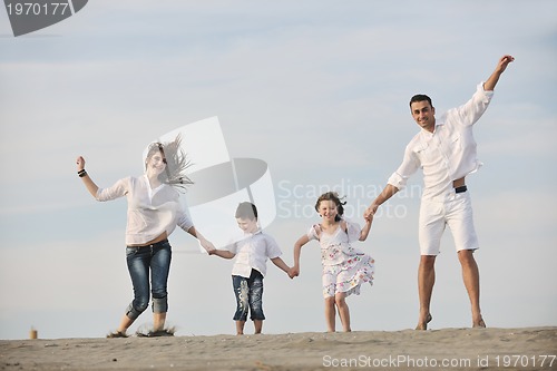 Image of happy young family have fun on beach