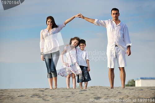 Image of family on beach showing home sign