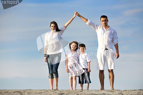 Image of family on beach showing home sign