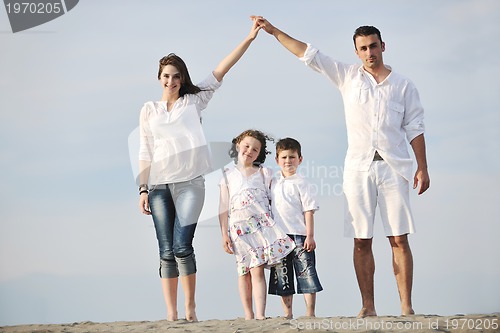 Image of family on beach showing home sign