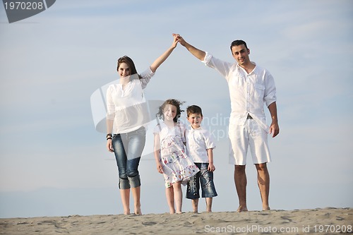 Image of family on beach showing home sign