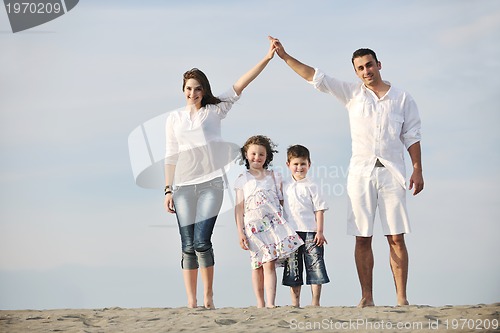 Image of family on beach showing home sign