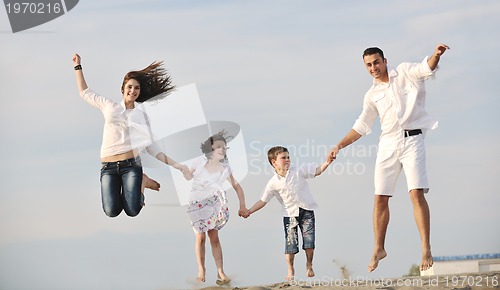 Image of happy young family have fun on beach