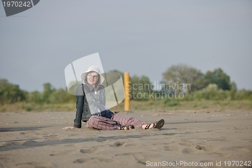 Image of happy young woman on beach