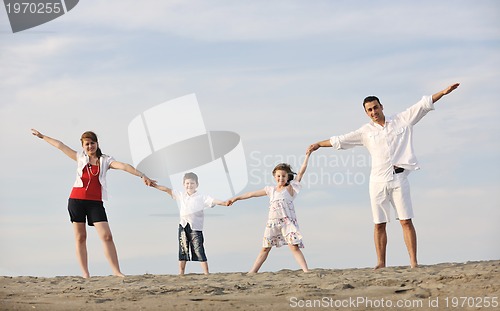 Image of happy young family have fun on beach