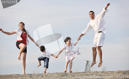 Image of happy young family have fun on beach