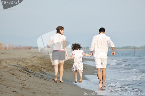 Image of happy young family have fun on beach