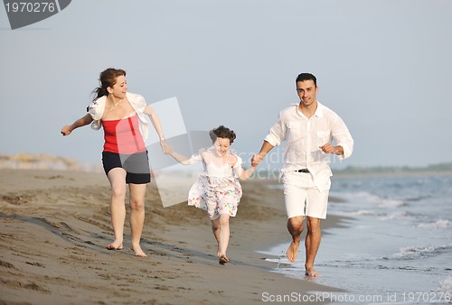 Image of happy young family have fun on beach