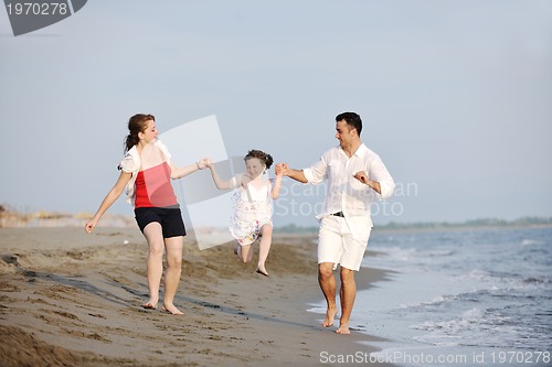 Image of happy young family have fun on beach