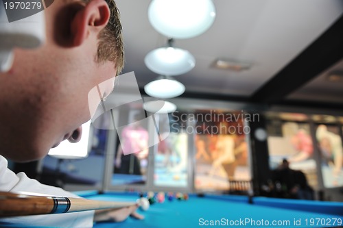 Image of young man play pro billiard game 