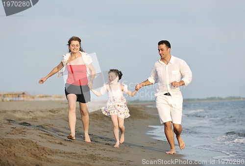 Image of happy young family have fun on beach