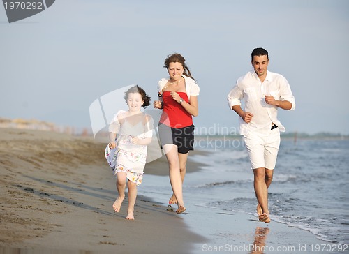 Image of happy young family have fun on beach