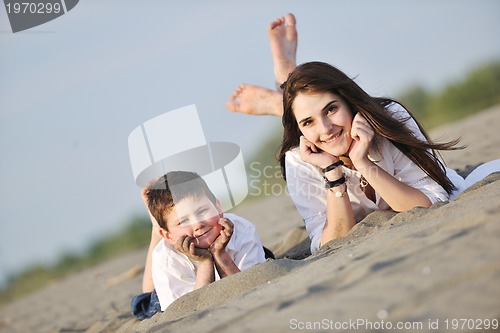 Image of mom and son relaxing on beach