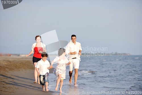 Image of happy young family have fun on beach