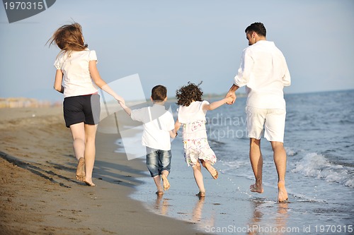 Image of happy young family have fun on beach
