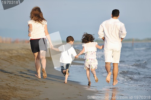 Image of happy young family have fun on beach