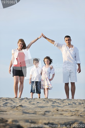 Image of family on beach showing home sign